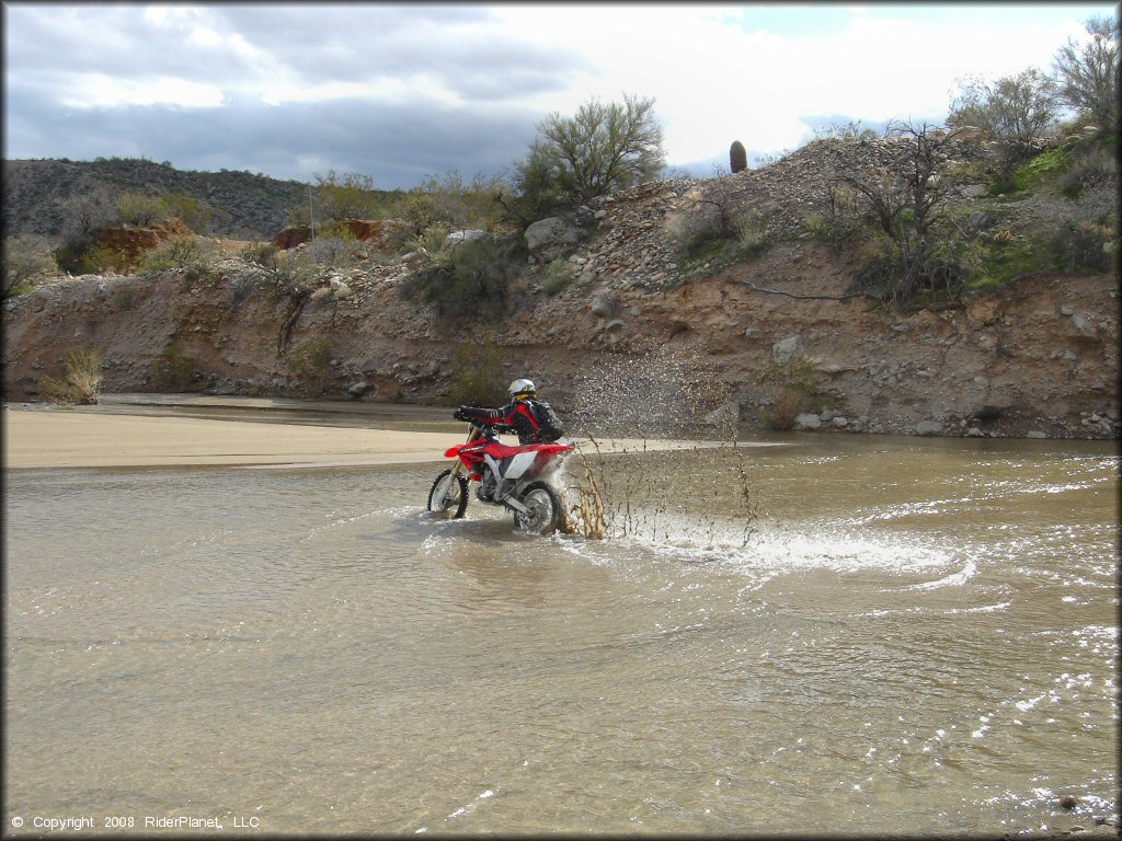 Honda CRF Motorcycle in the water at Black Hills Box Canyon Trail