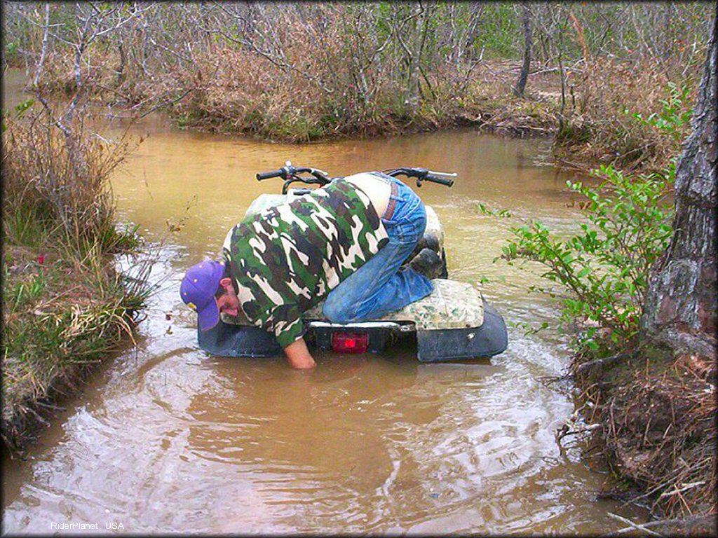 Quad traversing the water at Sand Hill ATV OHV Area