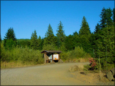 Campground entrance with kiosk stocked with informational flyers and trail maps.