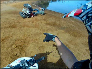 Young man pointing finger at friend who rolled ATV.