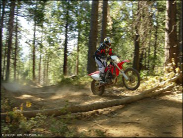 Honda CRF Off-Road Bike floating the front at Miami Creek OHV Area Trail