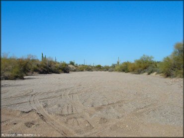 Photo of flat staging area with gravel and sand.