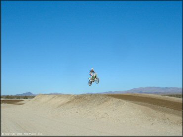 Kawasaki KX Motorcycle jumping at River MX Track