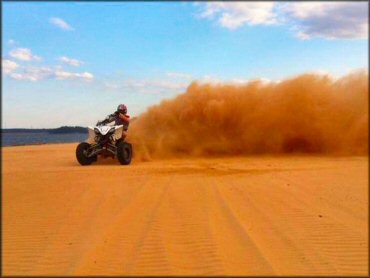 ATV doing a power slide in the sand.