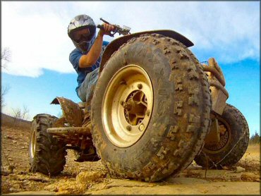 Close up photo of ATV with Maxxis mud tires.