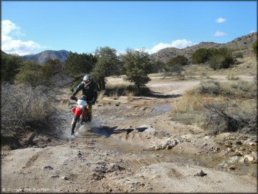 Honda CRF Dirt Bike getting wet at Redington Pass Trail