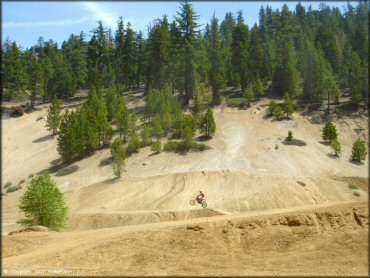 Honda CRF Motorcycle getting air at Twin Peaks And Sand Pit Trail
