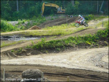 Honda CRF Motorbike catching some air at Crow Hill Motor Sports Park L.L.C OHV Area