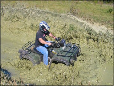 Honda ATV crossing some water at Big Rock Off Road Park Trail