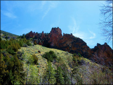 A scenic view of colorful rugged boulders on a hillside.