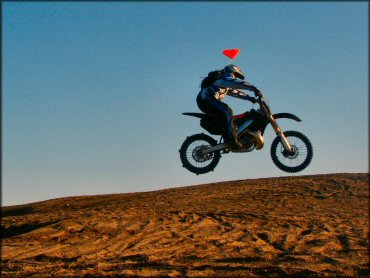 Honda CRF Motorcycle catching some air at Juniper Dunes Area