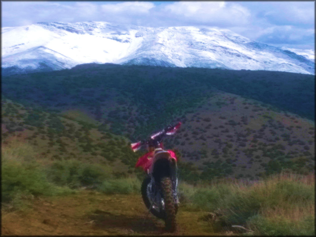 Honda Motorcycle On Trail With Mountain Backdrop