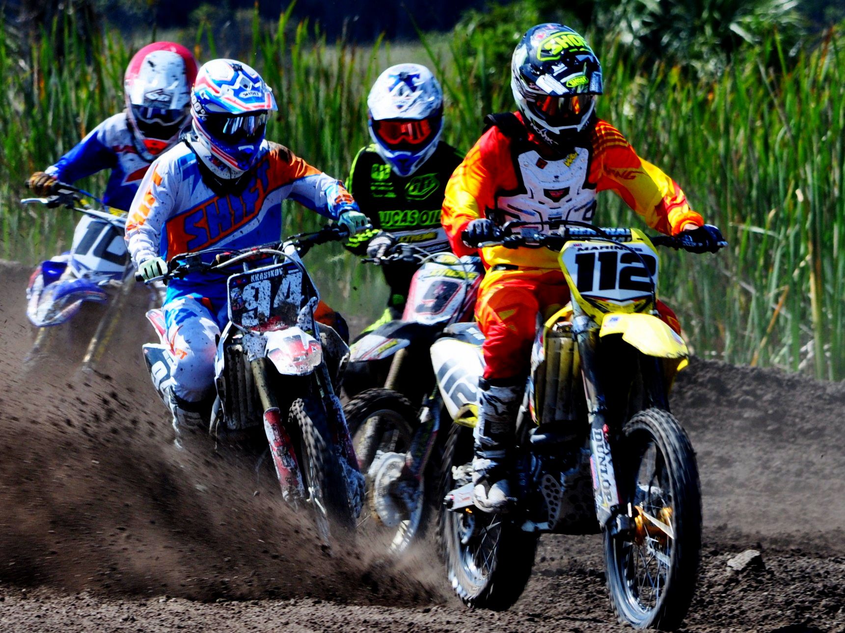 Four riders on motocross track wearing Shift and Lucas Oil riding gear.