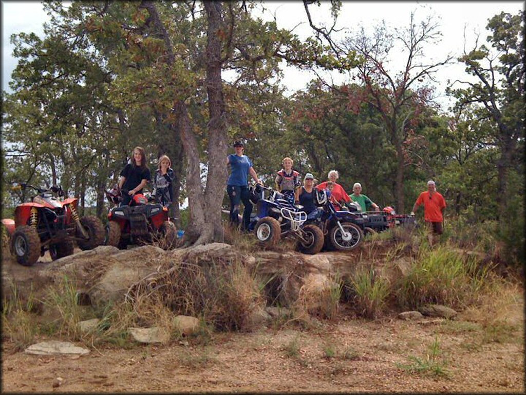 Group photo with five ATVs and one Yamaha dirt bike.