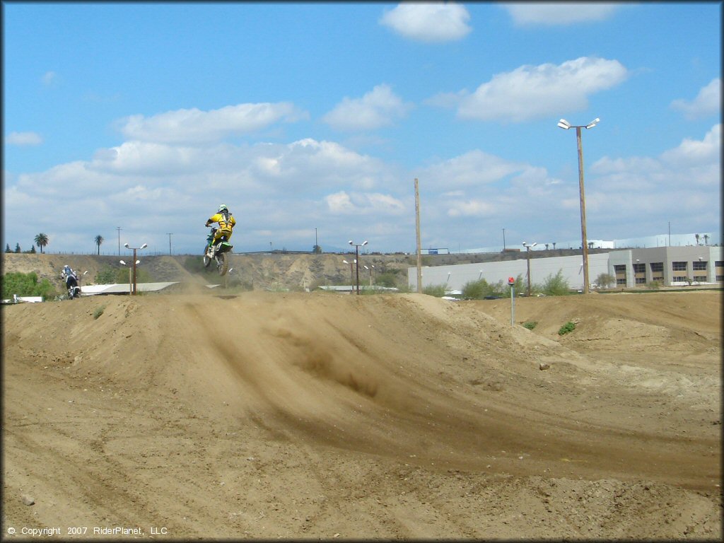 Kawasaki KX Motorcycle jumping at Milestone Ranch MX Park Track