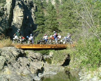 Trail Riders On Bridge