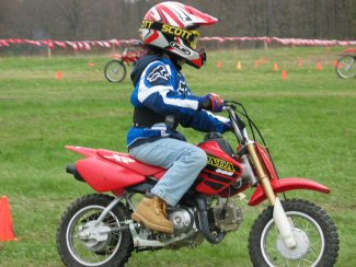 Child Learning To Ride a Dirt Bike