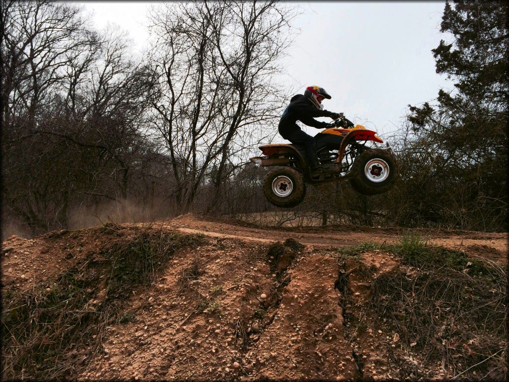 ATV rider jumping on motocross track