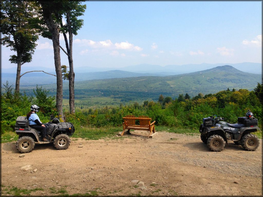 Woman on Artic Cat ATV overlooking scenic view near Ride The Wilds Trails.