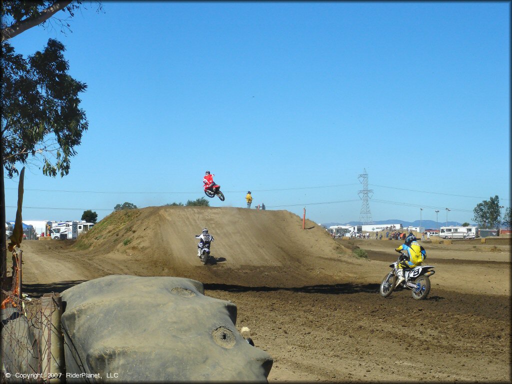 Dirt bike iders going up table top on motocross track at Argyll MX.