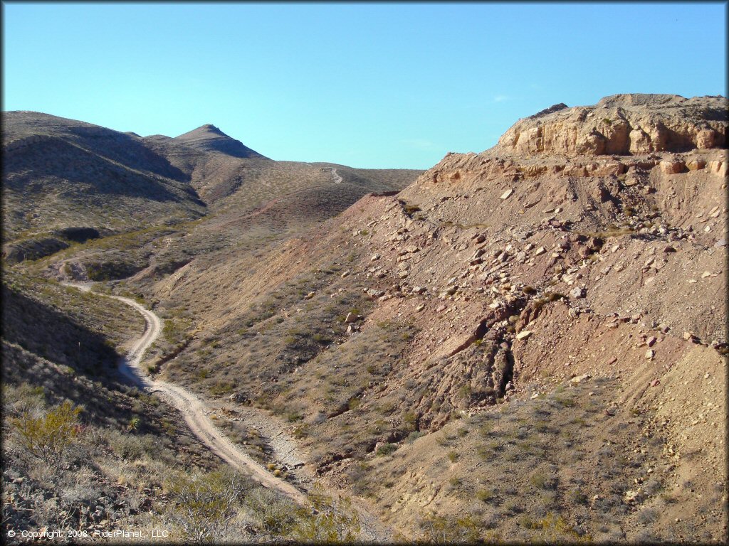 Jeep road winding through rugged canyon floor near Robledo Mountains OHV Area.