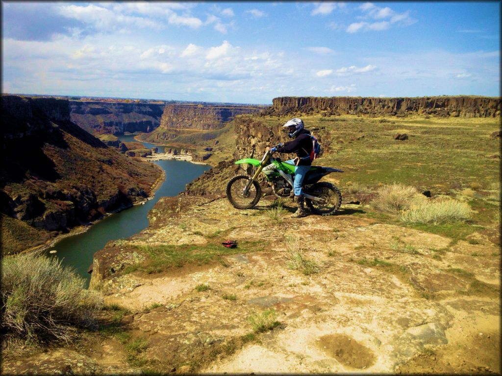 Dirt bike rider on Kawasaki overlooking the Snake River.