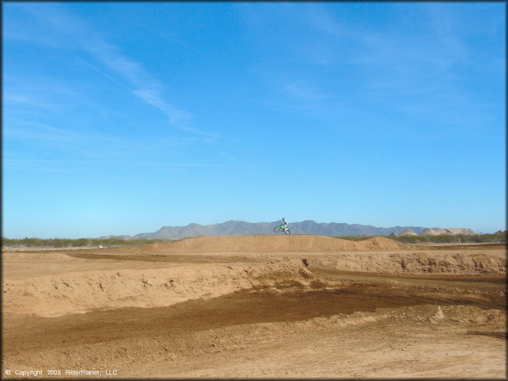 Kawasaki KX Motorcycle catching some air at Motoland MX Park Track