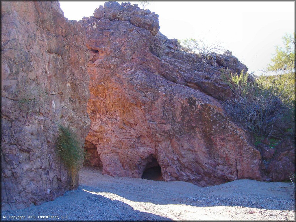 Side view of sand wash surrounded by rugged rock boulders.