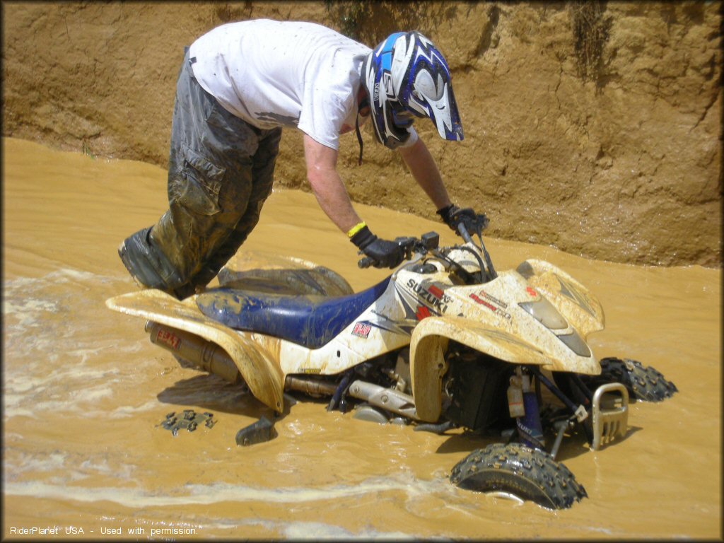 Suzuki ATV crossing the water at VMP-ATV OHV Area