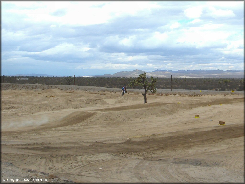 Dirt Bike getting air at Adelanto Motorplex Track