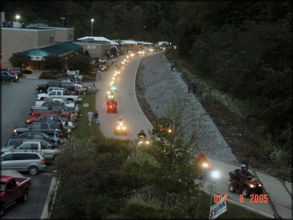 Large group of four wheelers going for a night ride.