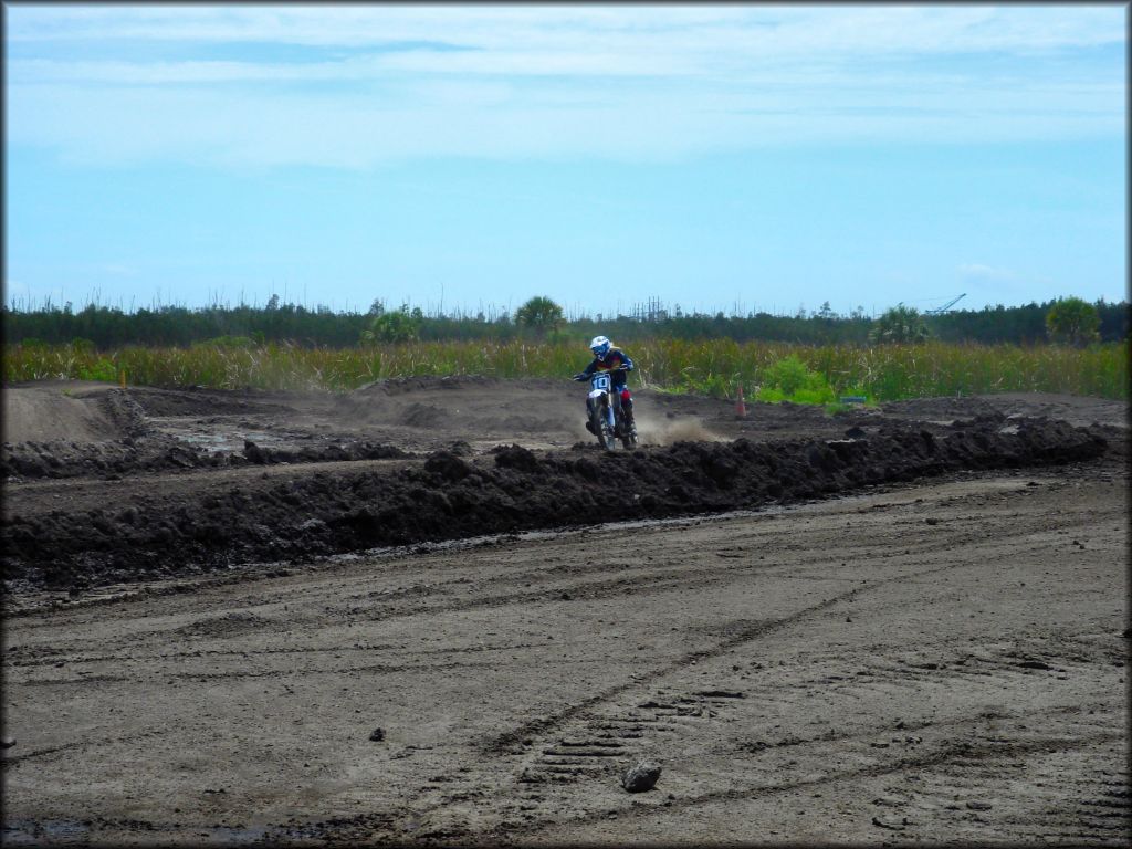 Young girl on blue Yamaha dirt bike.