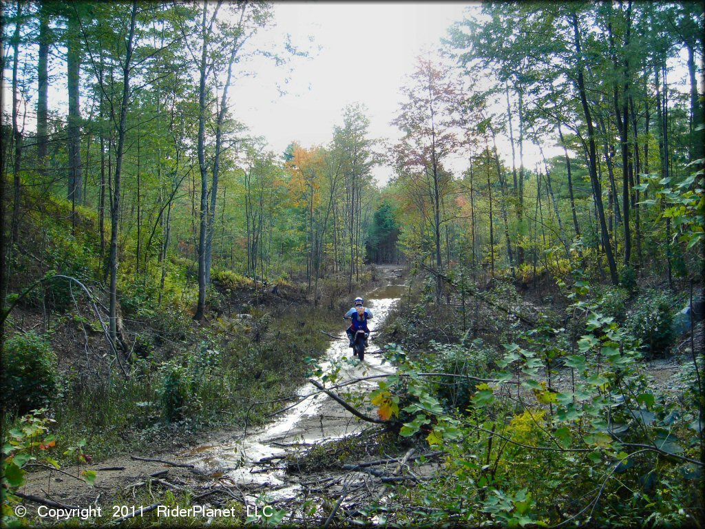 Honda CRF Motorcycle crossing some water at Hodges Village Dam Trail