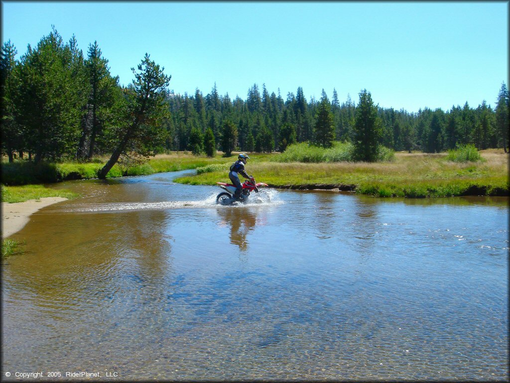 Honda CRF Motorcycle crossing some water at Lower Blue Lake Trail