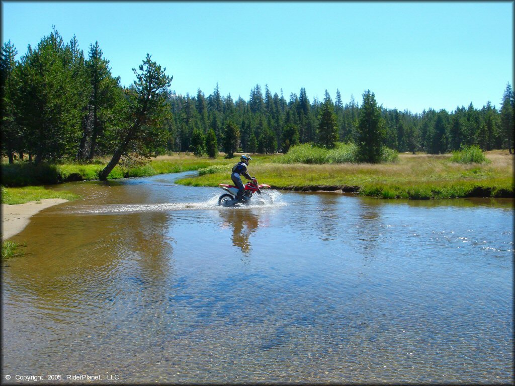 Honda CRF Dirt Bike in the water at Lower Blue Lake Trail