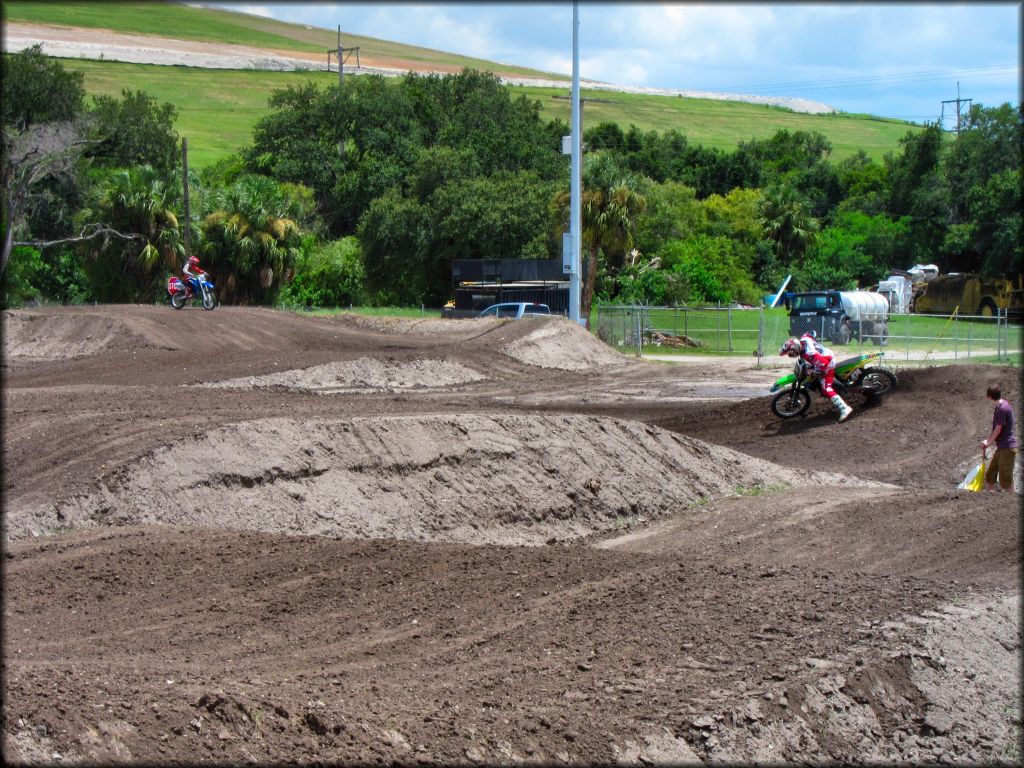 Kawasaki and Yamaha dirt bikes on the motocross track.