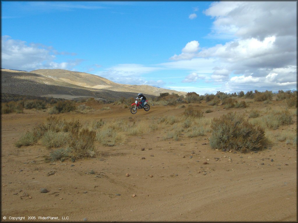 Honda CRF Dirt Bike getting air at Sunridge Track OHV Area