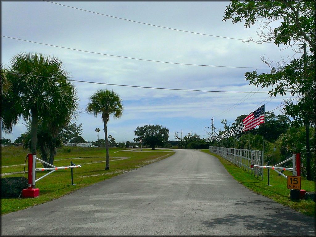 Main entrance road for park is ligned with American and race checkered flags.