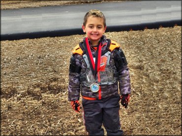 Young boy with Thor chest protector and camo jacket.