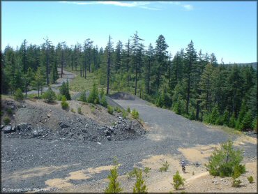 Aerial view of gravel pit and forest scenery.