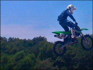 Kawasaki mini motocross bike catching some air.