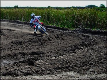 Cornering a berm on a Yamaha motocross bike.