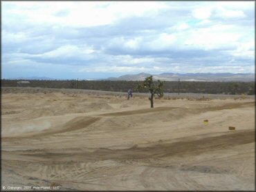 Motorcycle catching some air at Adelanto Motorplex Track