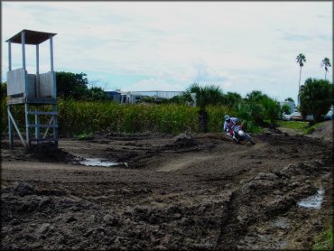 Man on Yamaha motocross bike taking sharp turn on track.