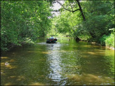 Quad traversing the water at Sandtown Ranch OHV Area