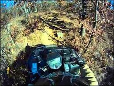 ATV navigating rough section of trail.
