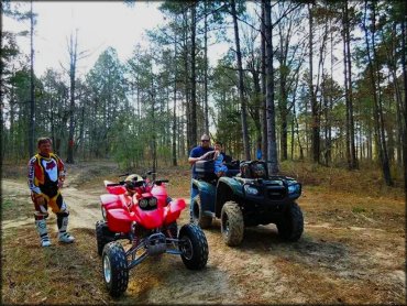 Man standing next to a Honda Fourtrax 400EX four wheeler