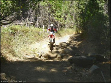 Honda CRF Dirtbike catching some air at Miami Creek OHV Area Trail