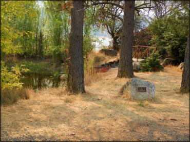 Shallow pond with a Rickard Pond memorial rock.