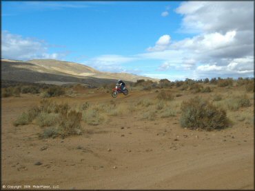 Honda CRF Motorbike catching some air at Sunridge Track OHV Area